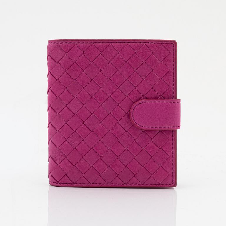 Bottega Veneta, a cerise leather wallet.