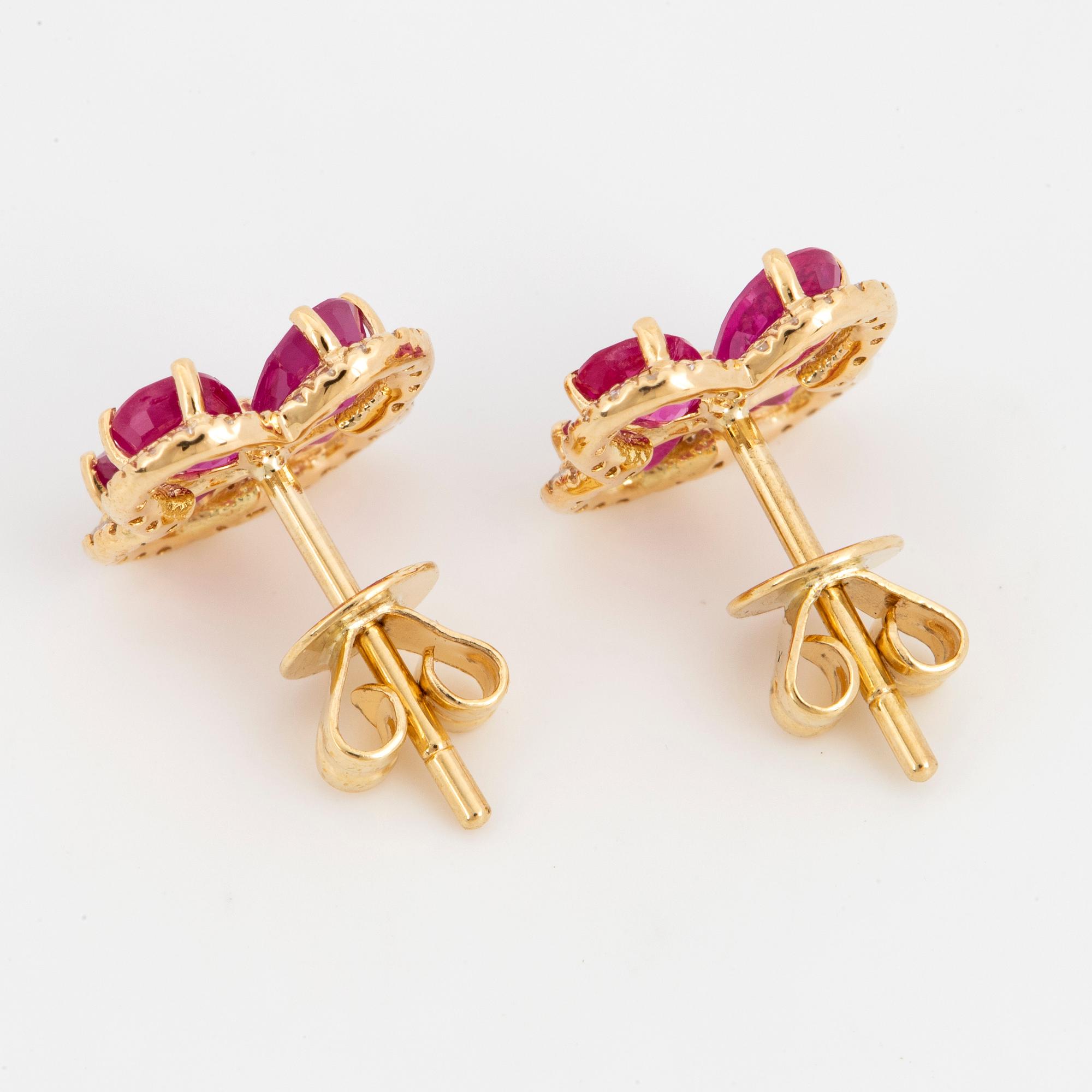 Pear shaped rubies and eight cut diamond flower earrings.