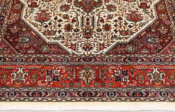 A Tabriz carpet, approximately 298 x 198 cm.