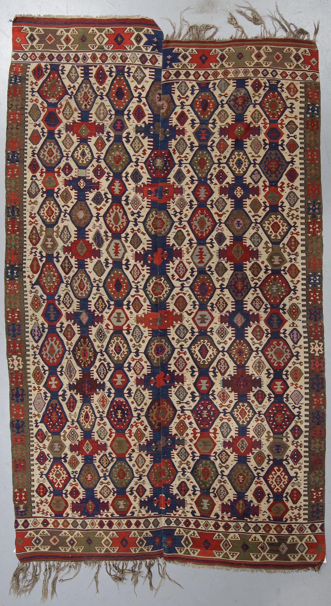 A carpet, a kilim, an antique Anatolian, ca 310-326 x 183,5-192 cm.
