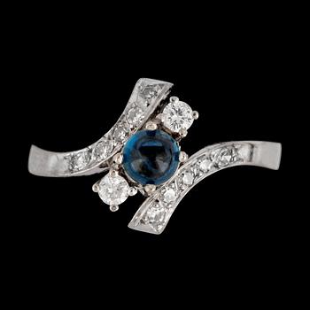 80. A blue cabochon cut sapphire and brilliant cut diamond ring, tot. app. 0.35 cts.