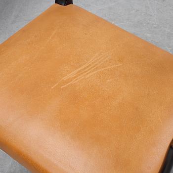 A set of four black stained beech tree arm chairs with leather upholstery, second half of the 20th century.