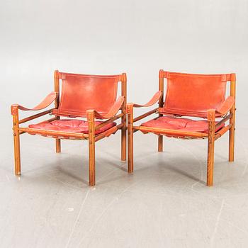 A pair of Arne Norell Sirocco jacaranda and leather easy chairs.