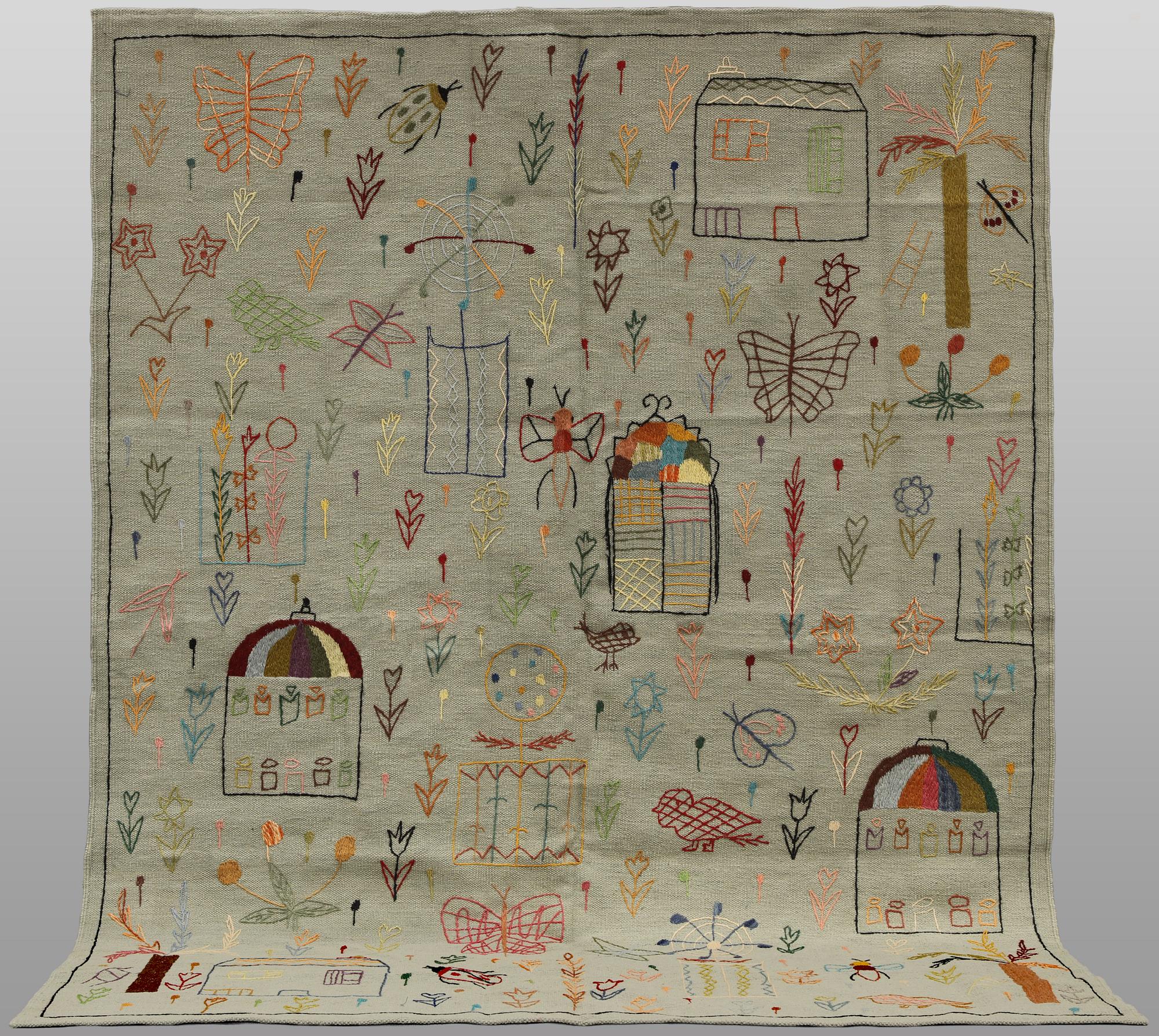 A hand-embroidered Kilim rug, approx. 241 x 183 cm.