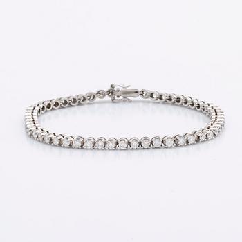TENNISARMBAND 18K vitguld m 54 briljanter ca 3 ct.