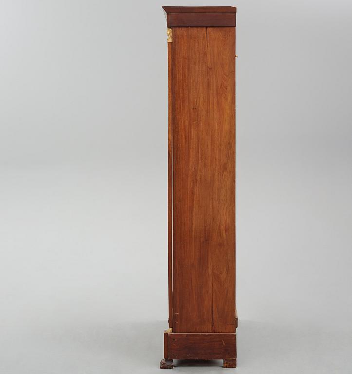 A French Empire mahogany and gilt-bronze mounted bibliothèque, early 19th century.