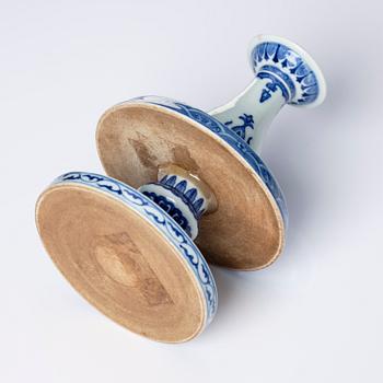 A pair of blue and white pricket candle sticks, with a poem, Qing dynasty with a Qianlong mark and of the period.