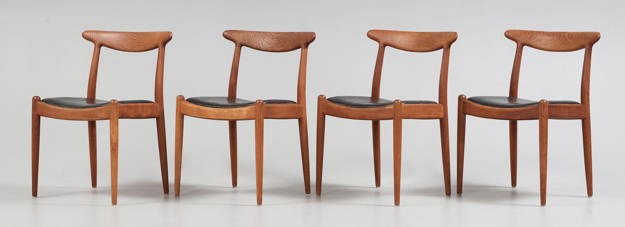 A Hans J Wegner oak dinner table 'AT 312' and four oak and black leather chairs, C M Madsen, Denmark 1950-60's.