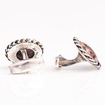 A set of three pairs of silver cufflinks with hematite, tigers eye and granite. Turun Hopea and Osvald Mättö.