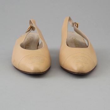 Beige leather slingbacks by Chanel.