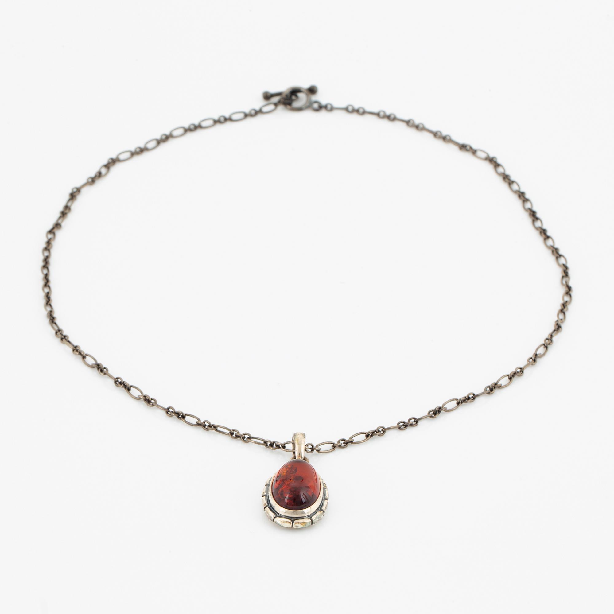 A Georg Jensen silver and cabochon-cut amber necklace.