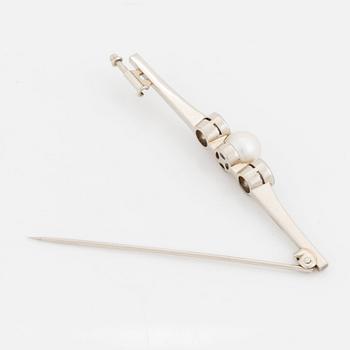 A 14K white gold brooch set with old-cut diamonds and a cultured pearl.