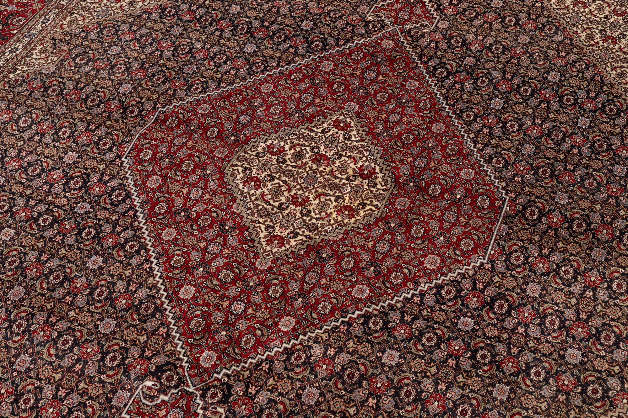 A signed Tabriz carpet, c. 385 x 300 cm.