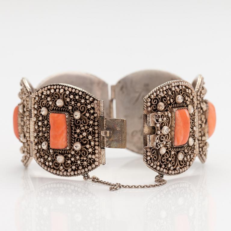 A silver bracelet with corals.