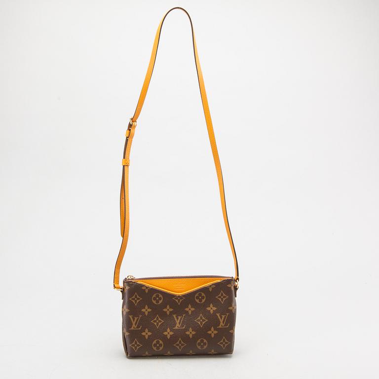 A Louis Vuitton Pallas clutch.