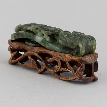 A green stone belt hook, China, early 20th Century.