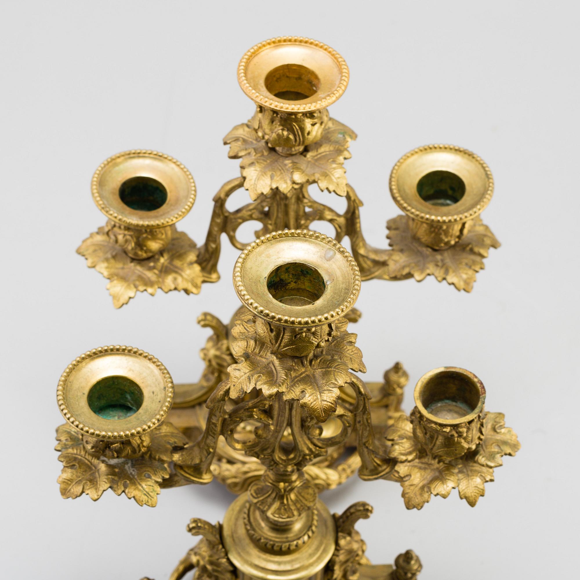 A table CLOCK and a pair of candelabra, second part of 19th century.