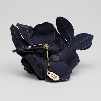 YVES SAINT LAURENT, a dark blue brooch.