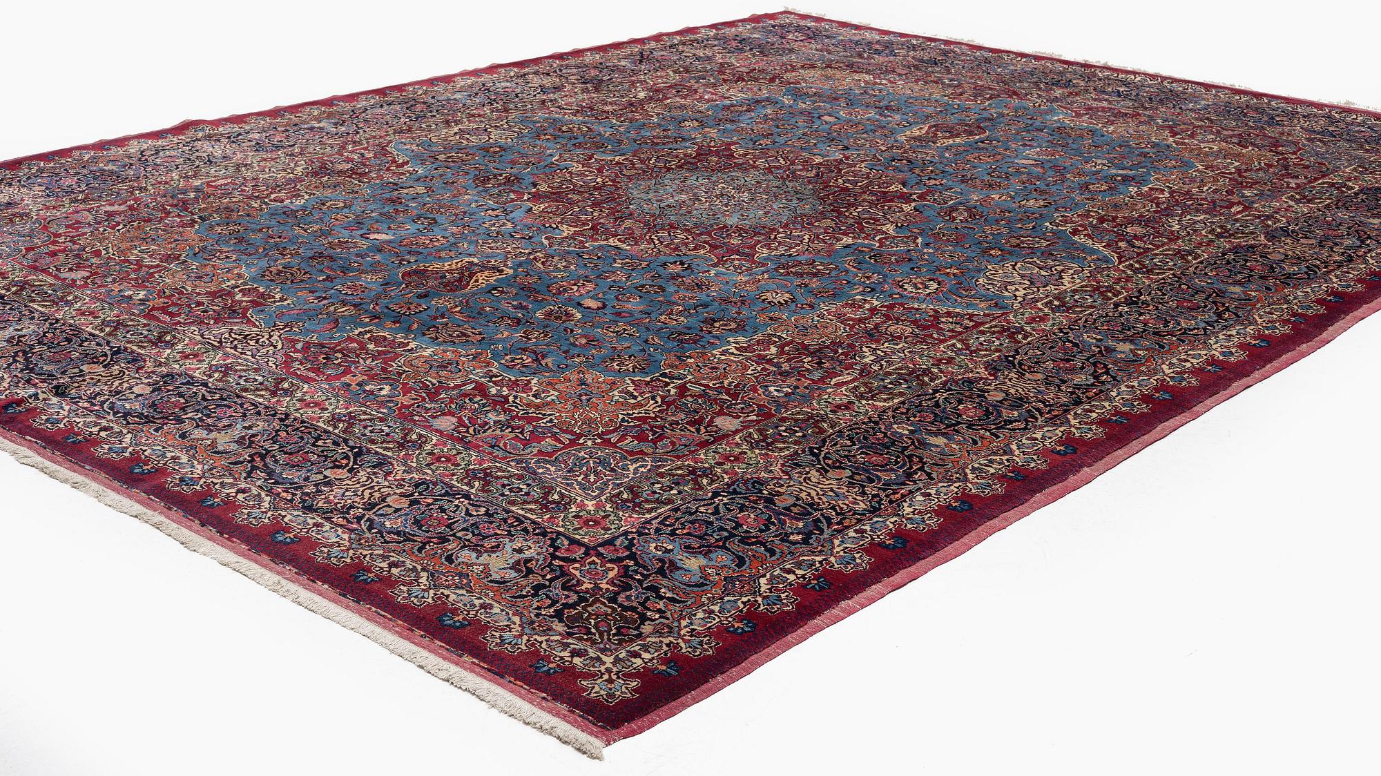 A Mashad carpet, signed Saber, c. 468 x 348 cm.