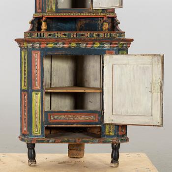 A SWEDISH CORNER CABINET, 1855.