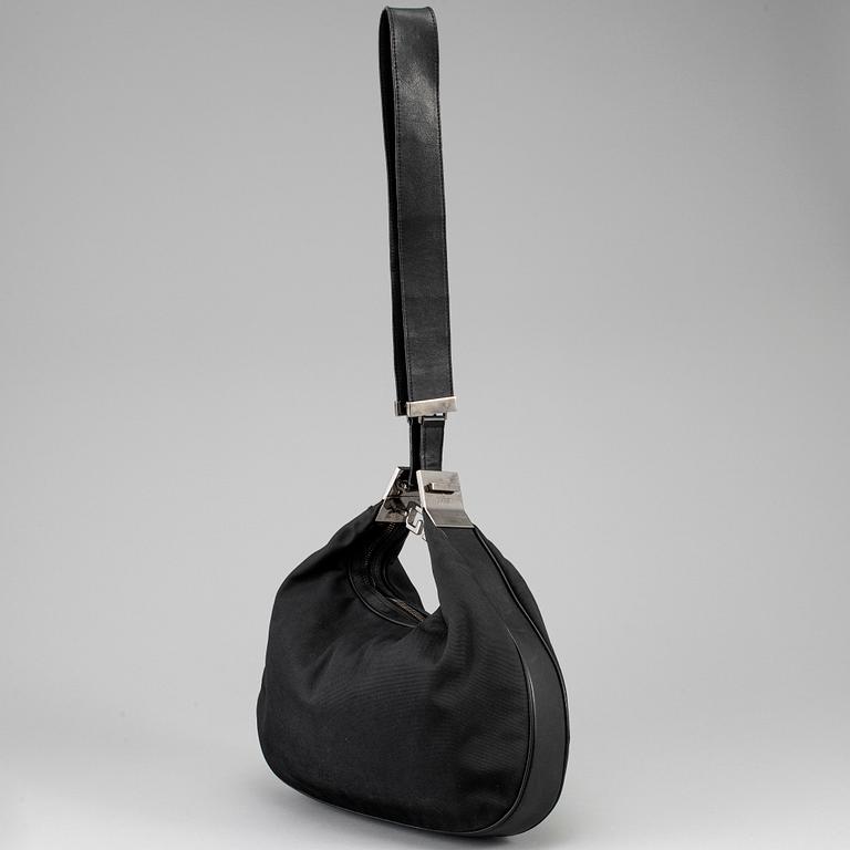 GUCCI, a canvas handbag.
