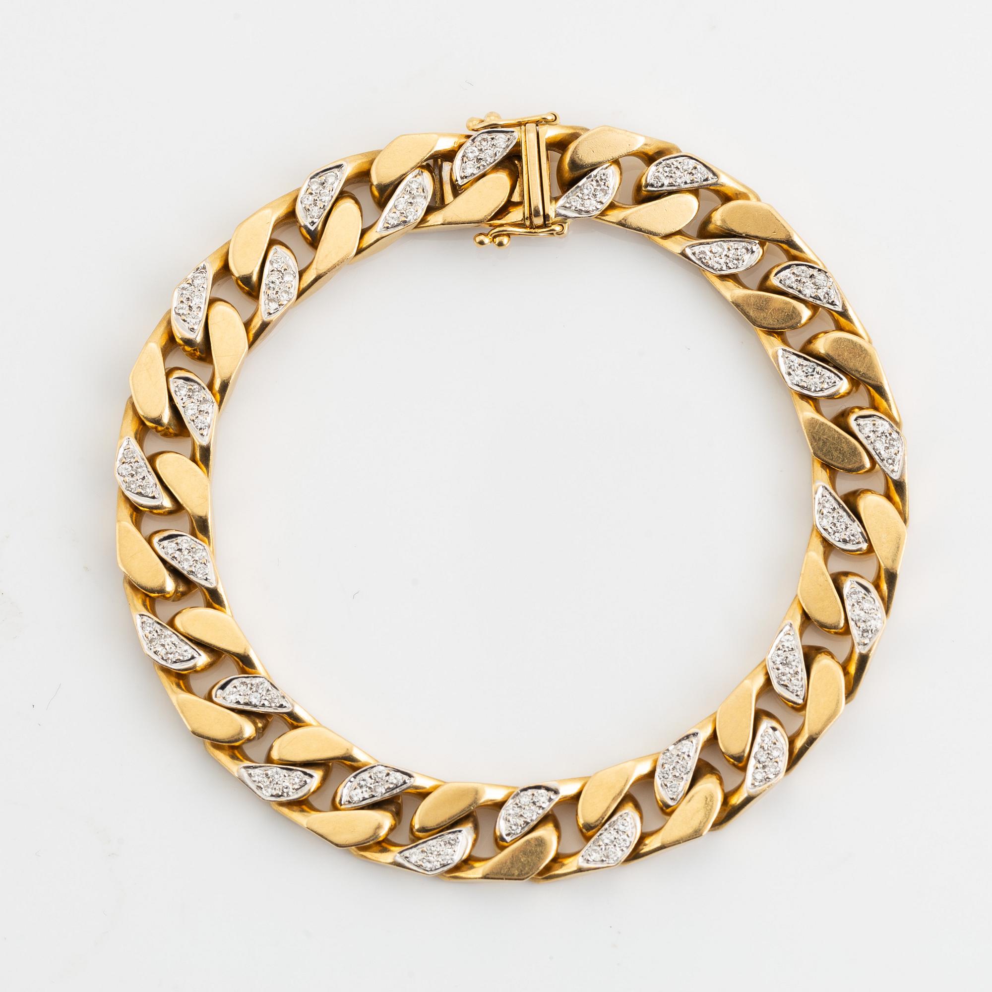 18K gold and brilliant cut diamond curb link bracelet.