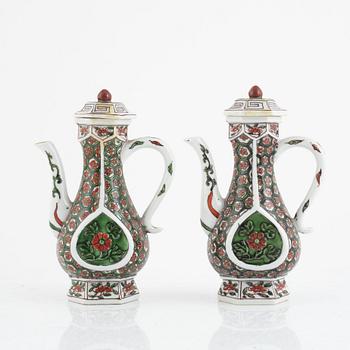 A pair of famille verte ewers and covers, 20th century.