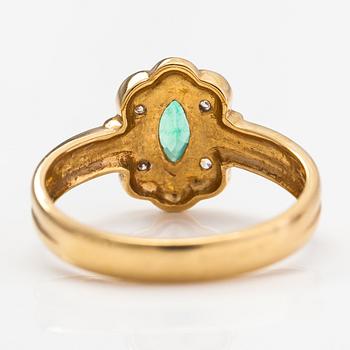 An 18K gold ring with diamonds ca. 0.02 ct and an emerald. Finnish import marks.