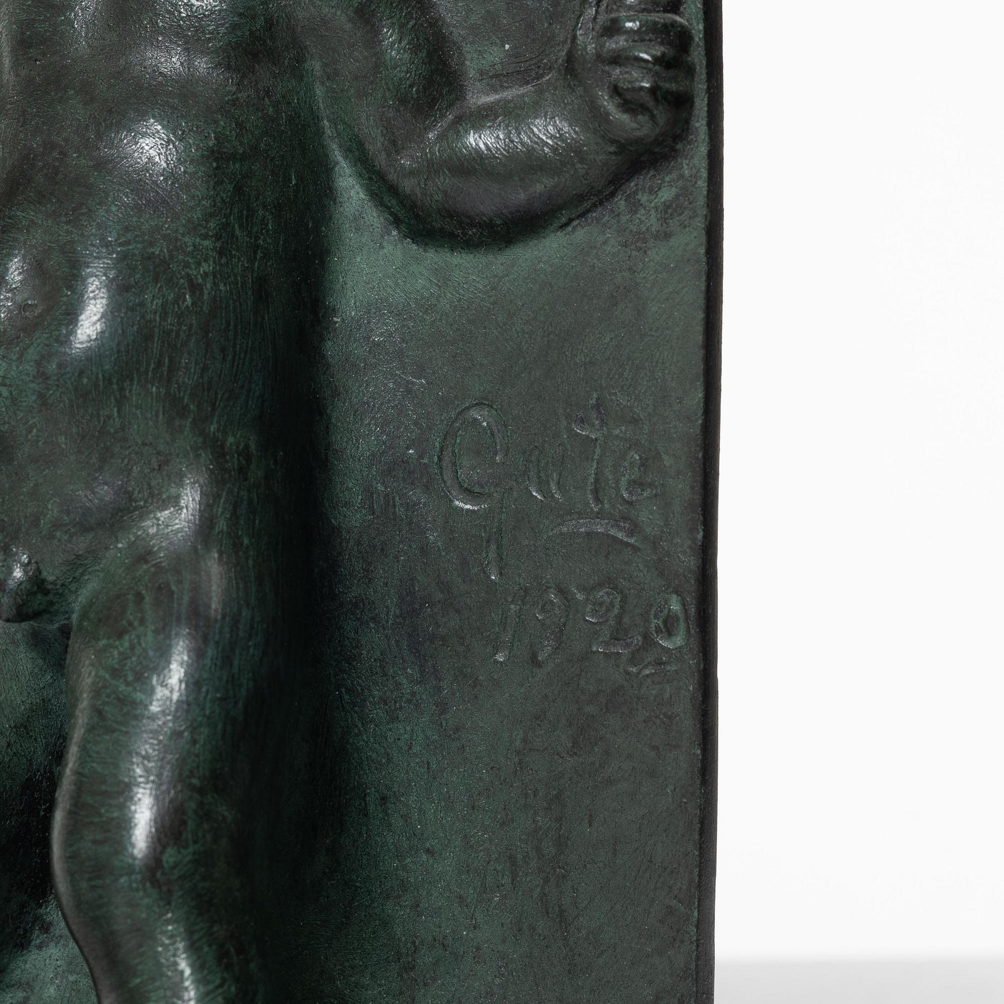 Axel Gute, a pair of patinated bronze bookends, dated 1920.