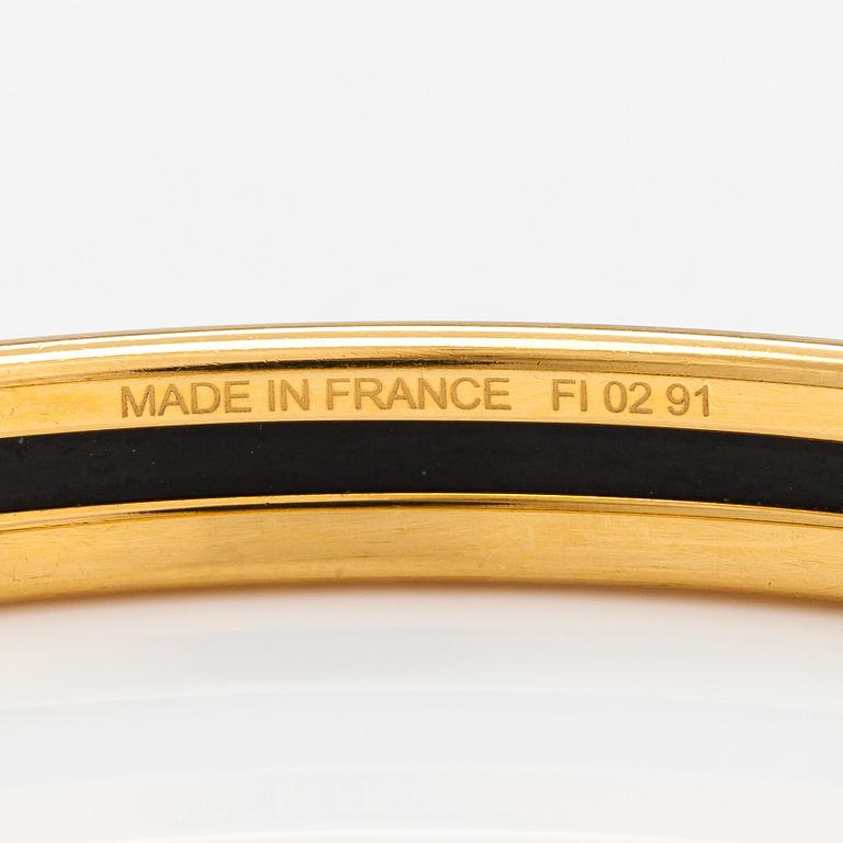 Hermès, a bracelet made of gold coloured metal and green enamel. Marked Hermès Paris, Made in France.