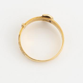 An 18K gold ring.