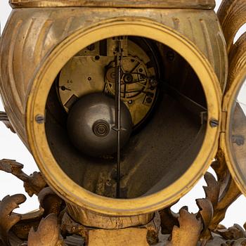 A grand mantle piece set with a clock and a pair of candelabras, Louis XV-style, second half of the 19th century.