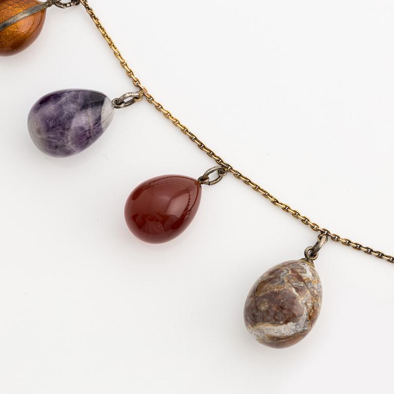 Necklace with jeweled egg, 14K gold and metal.