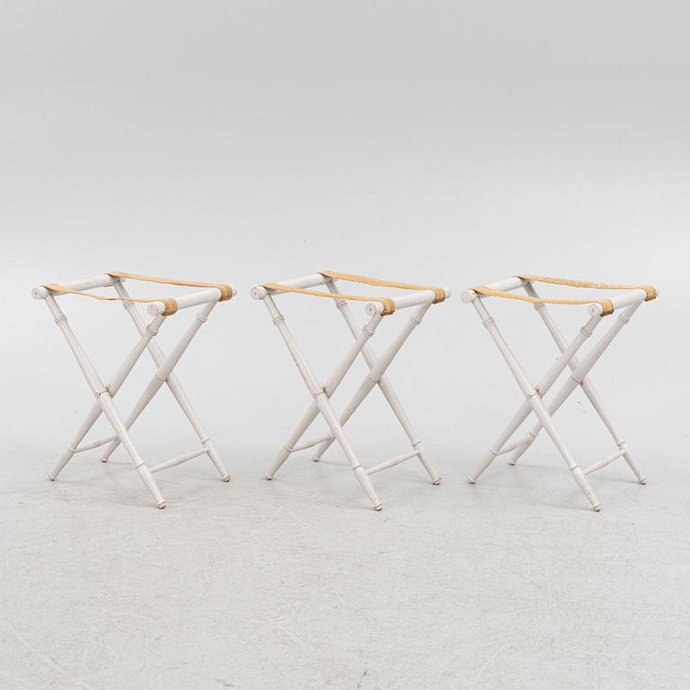 A set of three luggage stands, 20th century.