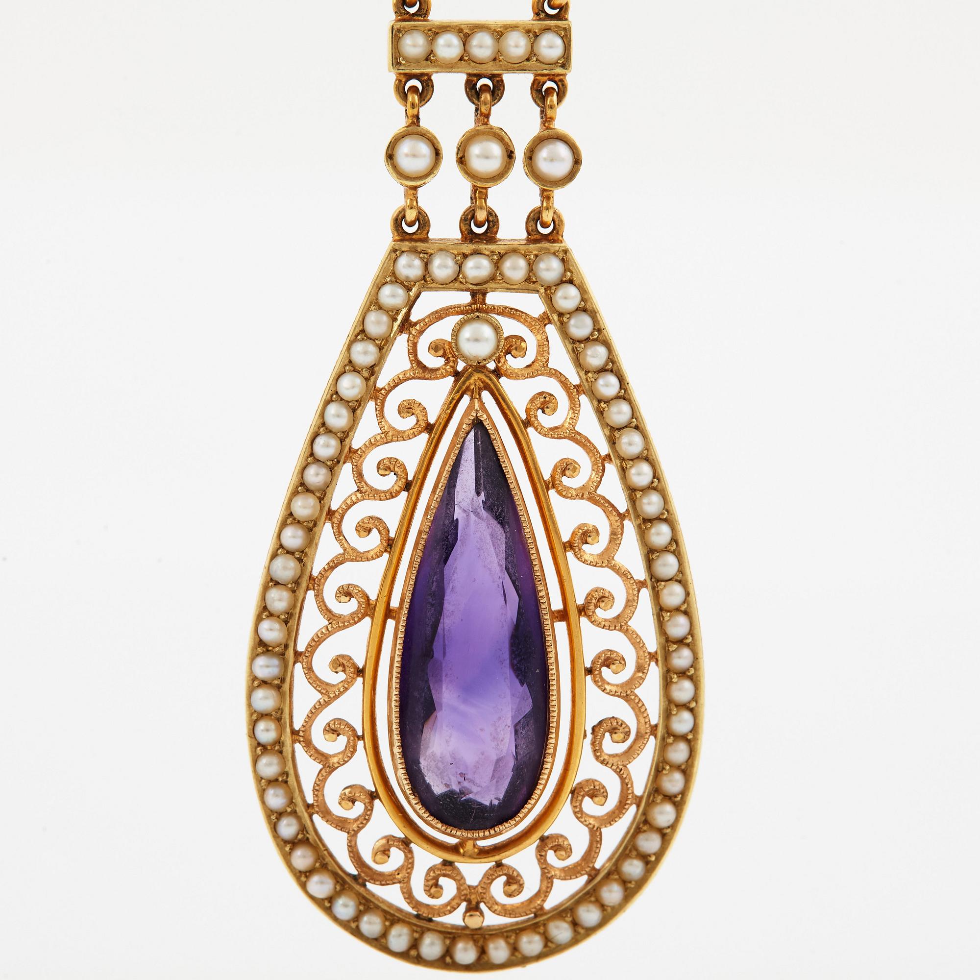 A 14K gold necklace set with a faceted amethyst and pearls.