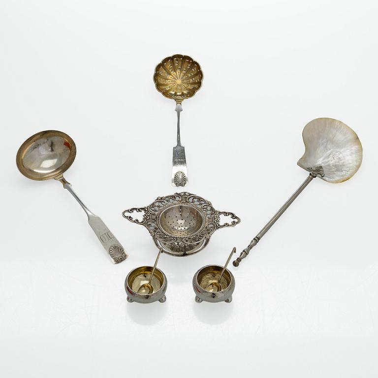 A pair of Russian silver salt cellars, a sprinkle spoon, a sauce ladle, and a tea strainer, Finnish marks.