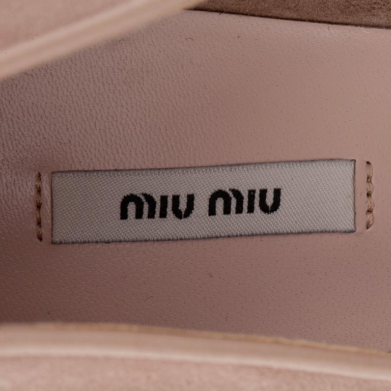 MIU MIU, a pair of beige suede pumps with sequined embellishment.