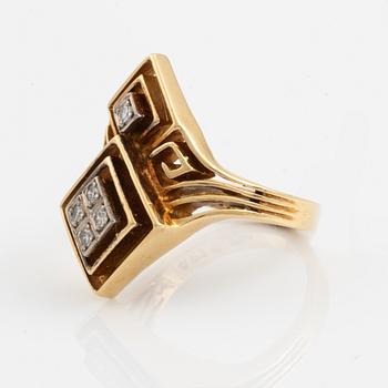 An Ilias Lalaounis ring in 18K gold set with eight-cut diamonds.
