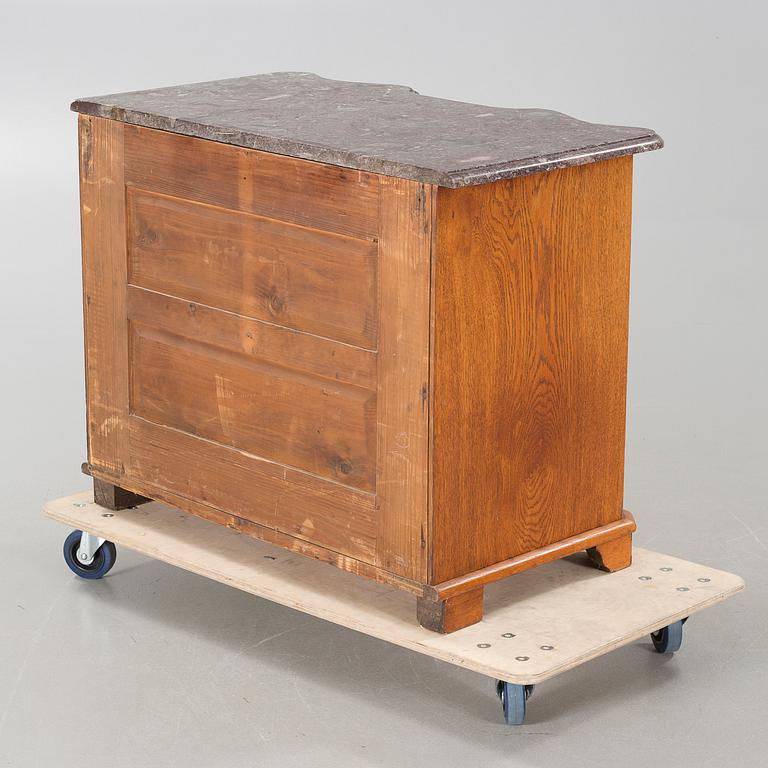 A baroque style chest of drawers, around the year 1900.