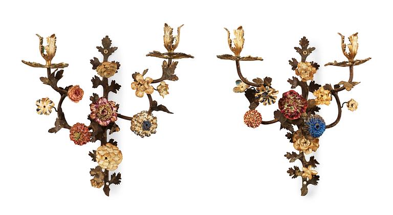A pair of Rococo 18th century gilt bronze, painted metal and porcelain two-light wall-lights, possibly Swedish.