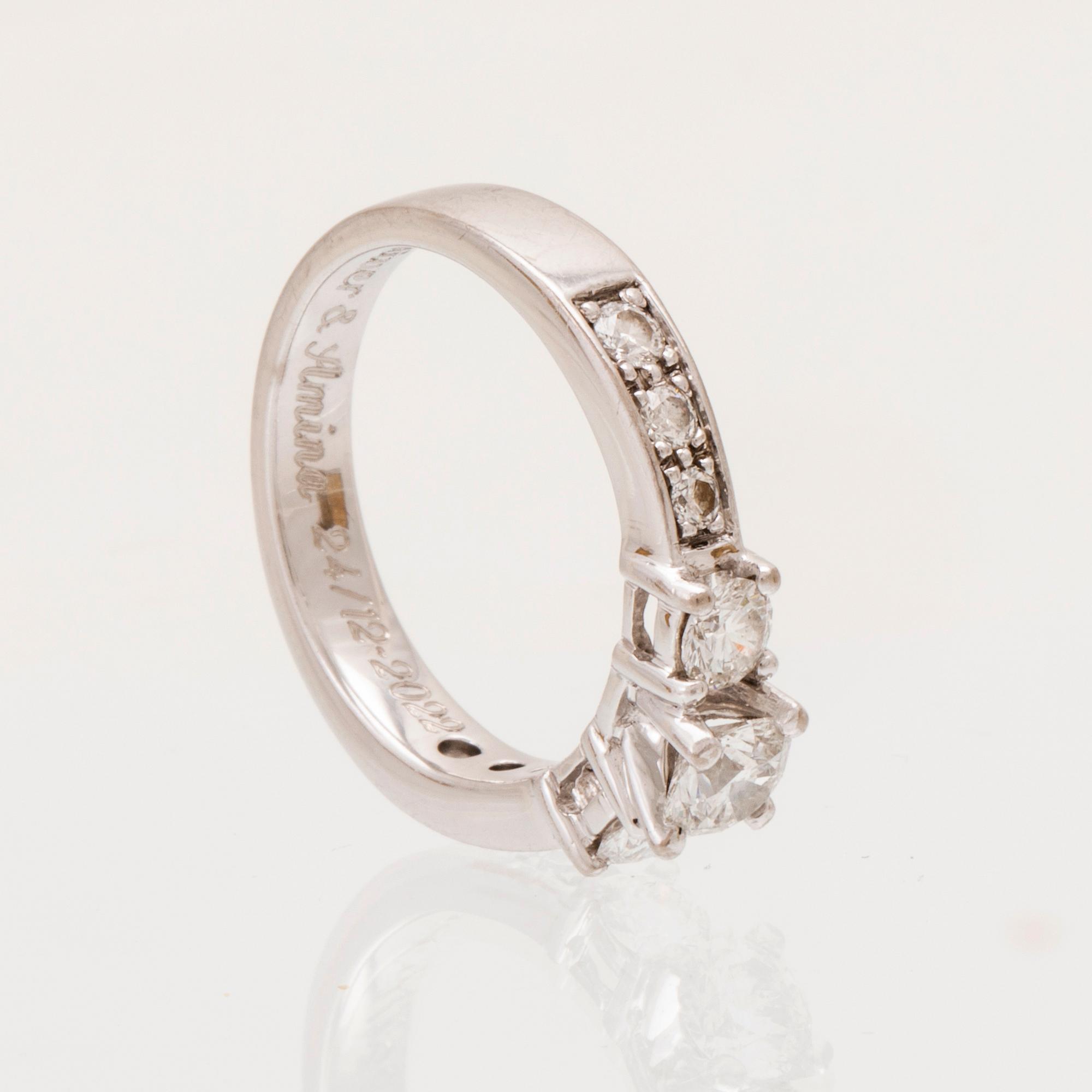 An 18K white gold ring set with round brilliant cut diamonds.