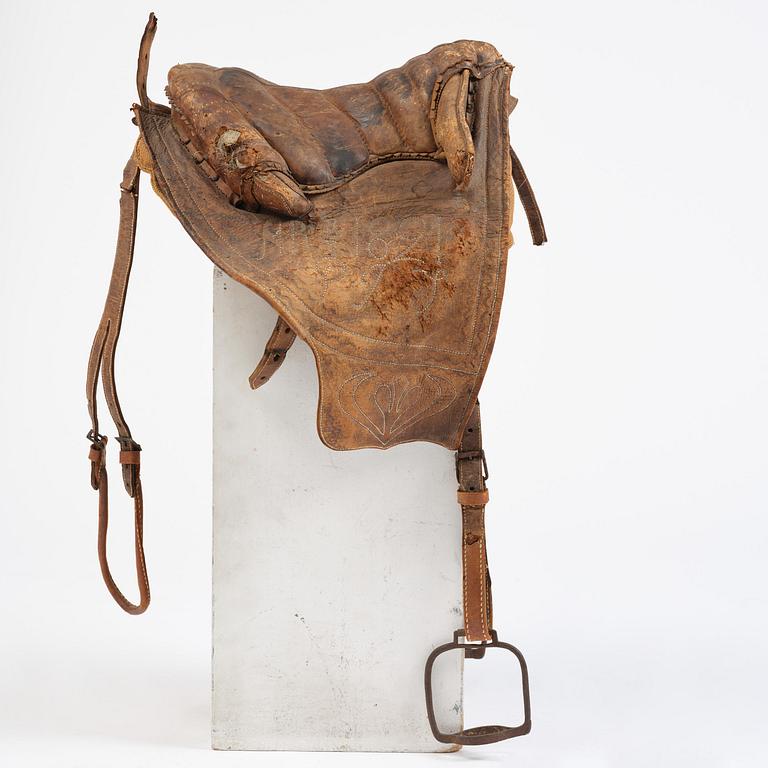 A leather saddle of Caucasian type, dated 1821.