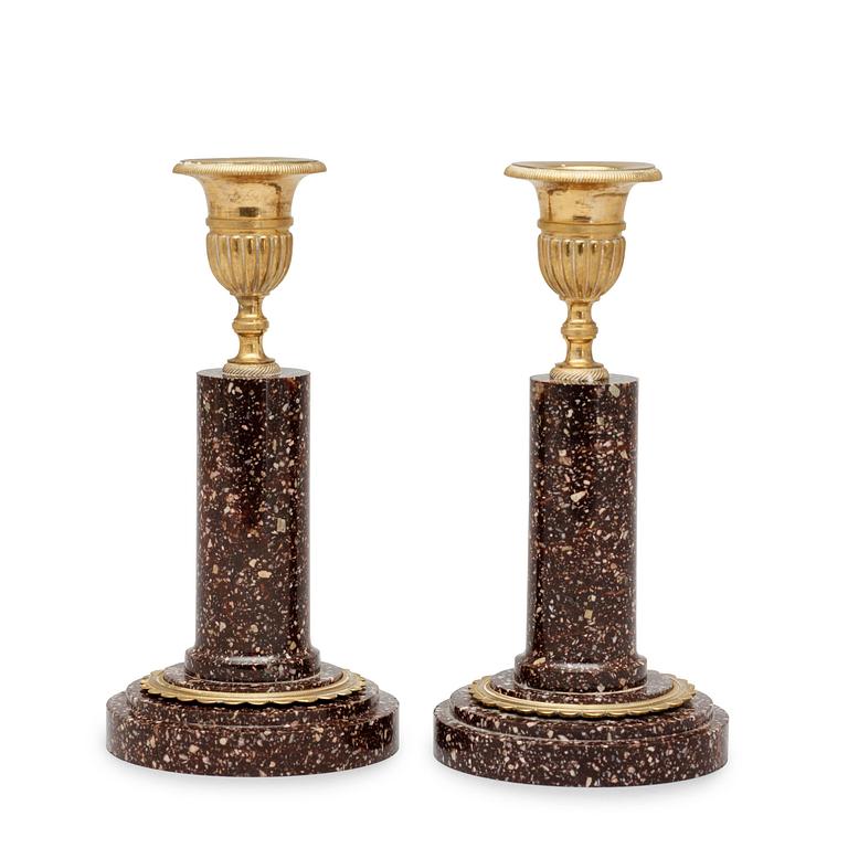 A pair of late Gustavian circa 1800 porphyry and gilt bronze candlesticks.