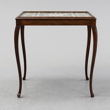 An oak table with glazed tiles by  Anna-Lisa Thomson, S.t Erik, dated 1931.