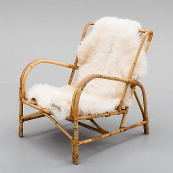 a mid 20th century rattan easy chair.