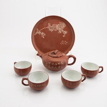 A Chinese 20th century Yixing ware tea service and a porcelain tea caddie.