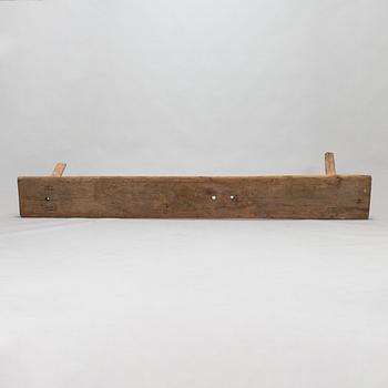 An 18th-century wooden bench dated 1782 with initials.