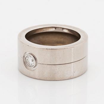 A Cartier 18K white gold ring set with a round brilliant-cut diamond.
