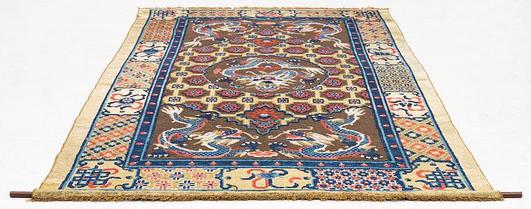 A Chinese silk and metal thread yellow ground 'five clawed dragon' carpet, Qing dynasty, 19th century. (Measure 208x126).
