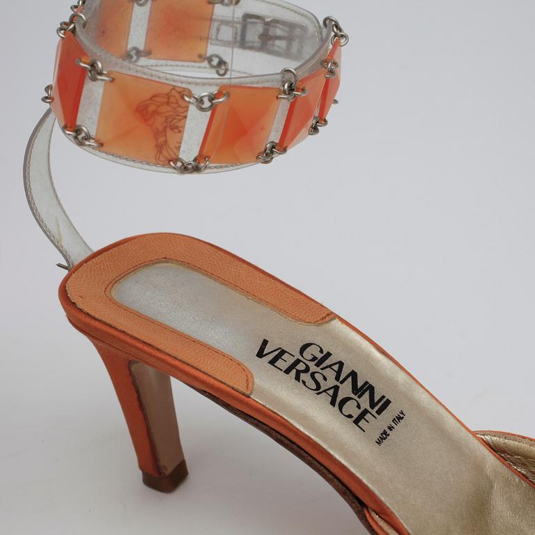 GIANNI VERSACE, a pair of orange lady's shoes and a handbag.